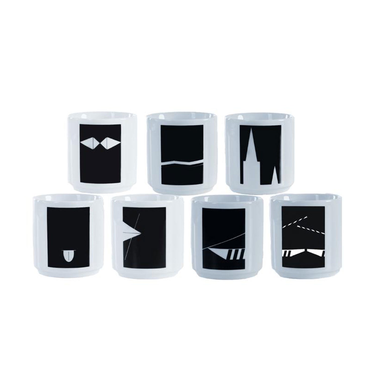 Sieben weiße Becher des Ulmer Wahrzeichen-Sets sind in zwei Reihen auf schlichtem Hintergrund angeordnet. Jeder Becher zeigt ein markantes schwarzes geometrisches Design, das das künstlerische Flair von Donaukind mit einem modernen und abstrakten Touch verkörpert.