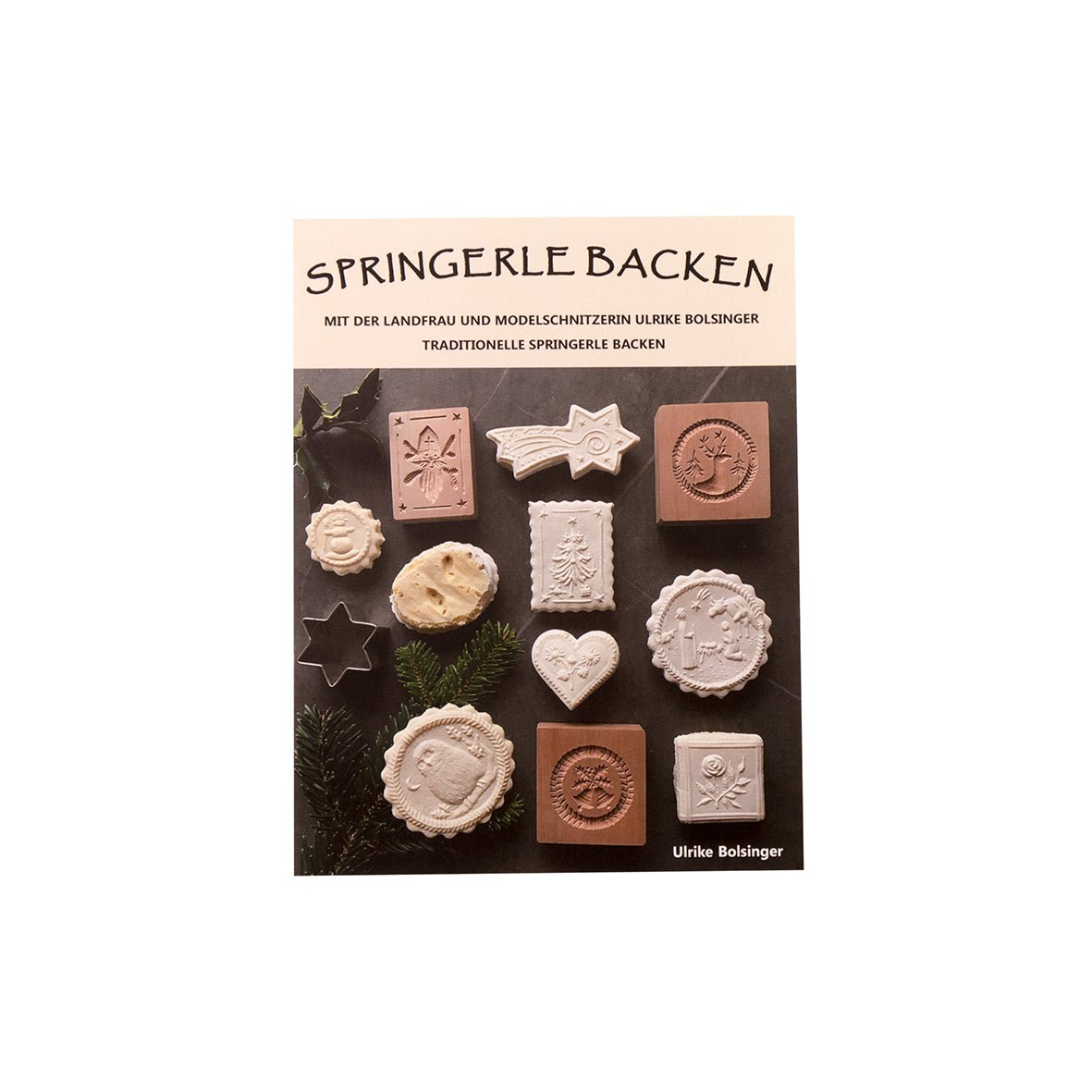Das Cover von „Springerle backen – Backbuch von Ulrike Bolsinger“ zeigt aufwendig geformte Springerle Weihnachtsbildgebäcke und Anisgebäcke in Weiß und Braun, kunstvoll arrangiert auf dunklem Hintergrund mit Tannenzweigen.