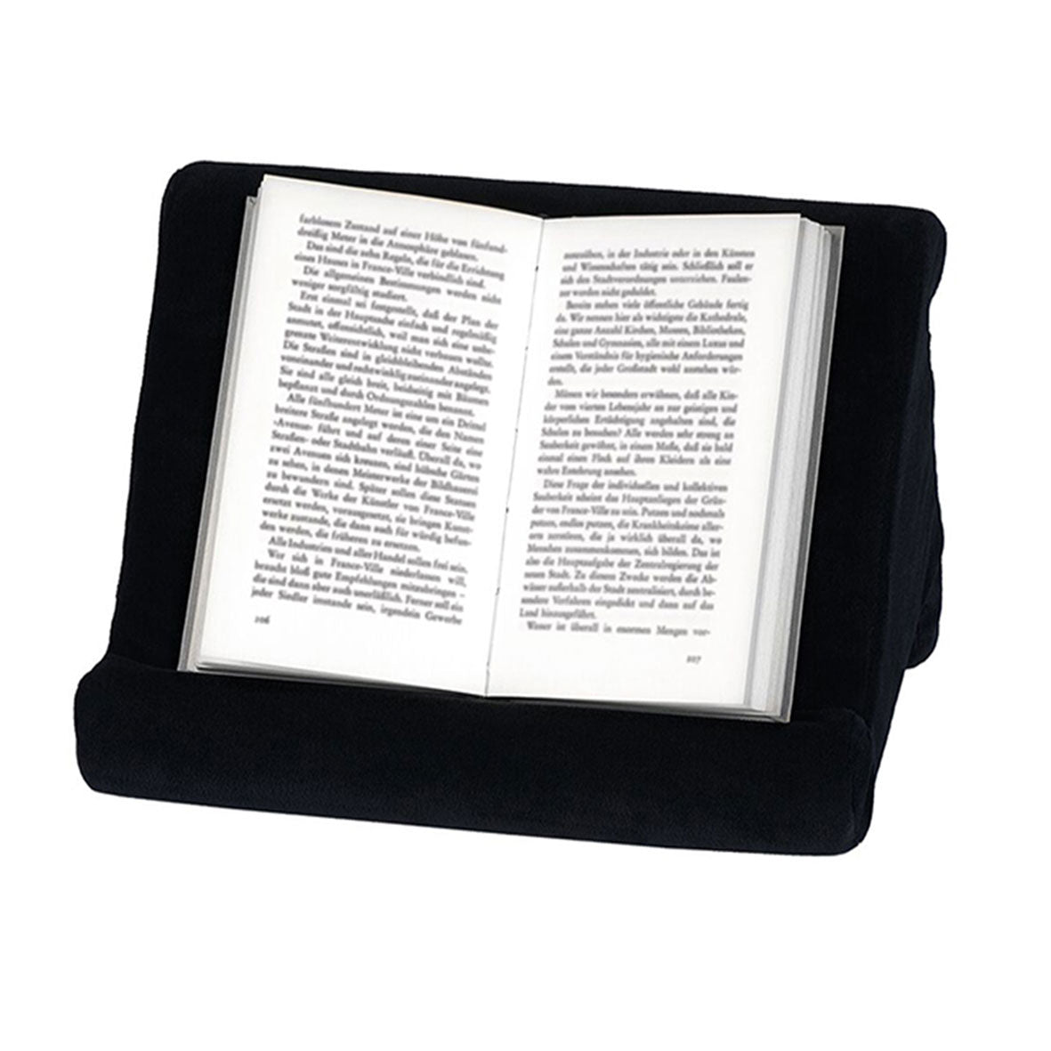 Auf dem keilförmigen Lesekissen Pause aus schwarzem Samt liegt ein fremdsprachiges Buch, das schräg gestützt wird und dessen sauber gedruckter Text sich über zwei Seiten erstreckt.